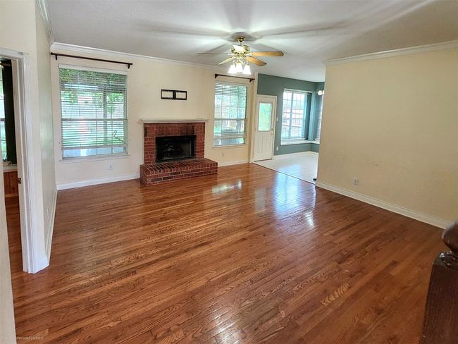 Featuring natural wood finished floors, a gas fireplace | Image 6