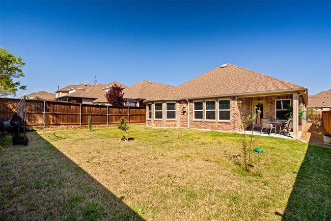 Back of property with a patio, roof with shingles, brick siding, a fenced backyard, and a yard | Image 20