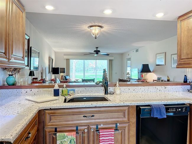 kitchen counter opens to dining and main living spaces | Image 21