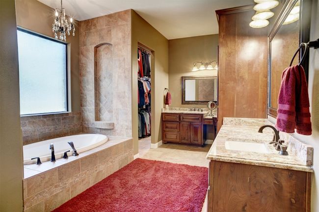 Primary Bathroom features a large walk-in shower, separate tub, two vanities, two walk-in closets. | Image 14
