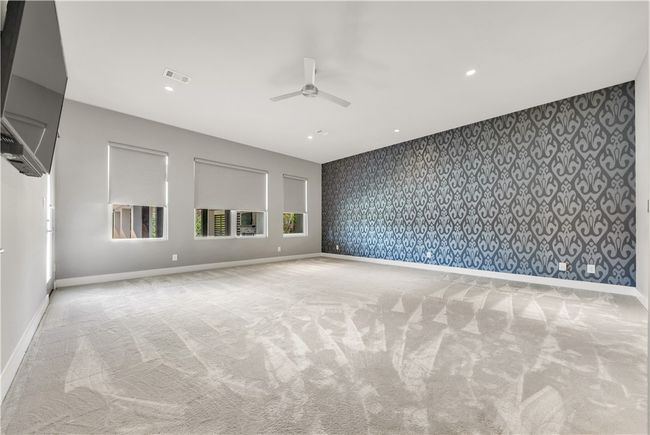 Unfurnished room with wallpapered walls, a ceiling fan, carpet, an accent wall, and recessed lighting | Image 15