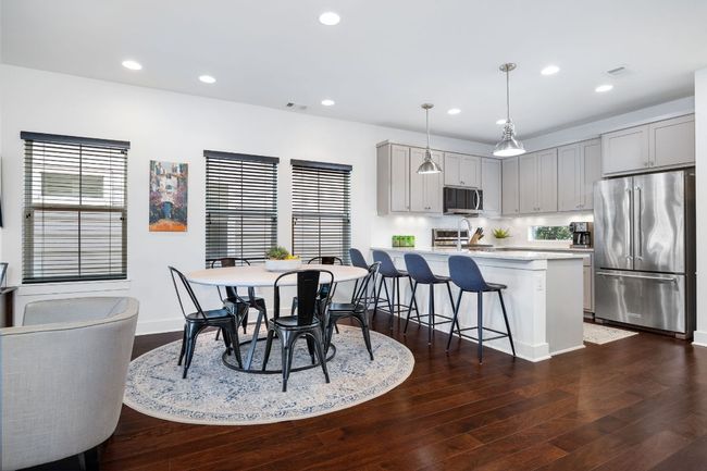 Gorgeous dark wood floors, recessed lighting and a spacious open floor plan. | Image 18