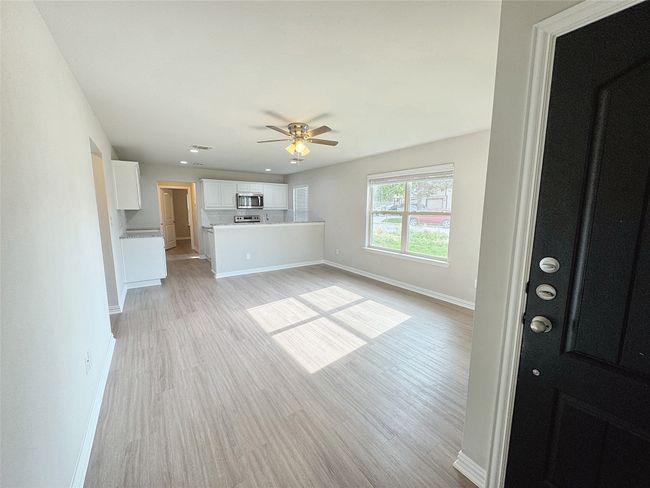 Unfurnished living room featuring a ceiling fan, light wood-style floors, and recessed lighting | Image 5