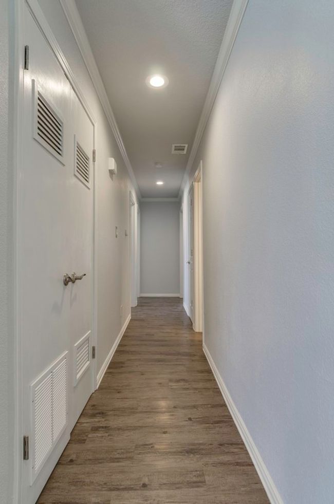 Corridor with ornamental molding, dark wood-style floors, and recessed lighting | Image 20
