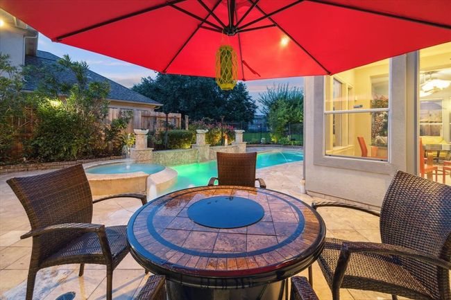 Enjoy the scenic views of your lavish backyard while relaxing in the shade. | Image 35