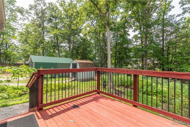 Wooden terrace with a storage shed and view of scattered trees | Image 35