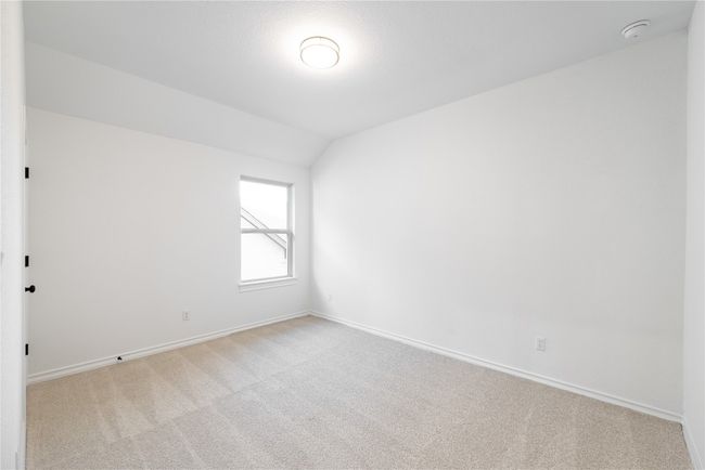 Carpeted empty room featuring lofted ceiling and baseboards | Image 14