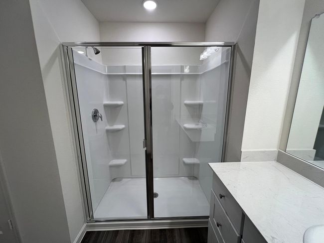 Bathroom with a shower stall, vanity, and wood finished floors | Image 15