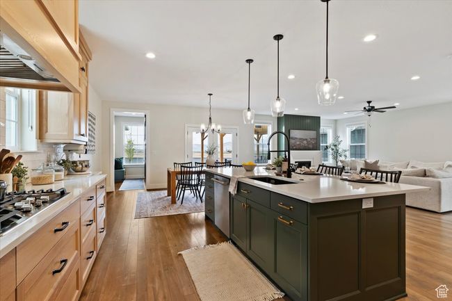 Kitchen featuring a sink, recessed lighting, light countertops, appliances with stainless steel finishes, and premium range hood | Image 14