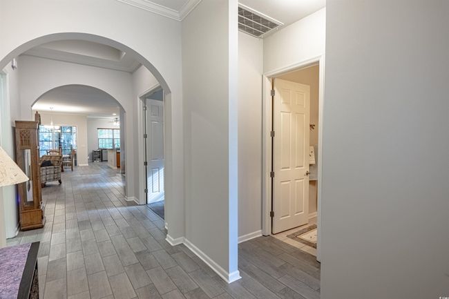 Corridor with wood-type flooring, an inviting chandelier, and crown molding | Image 7