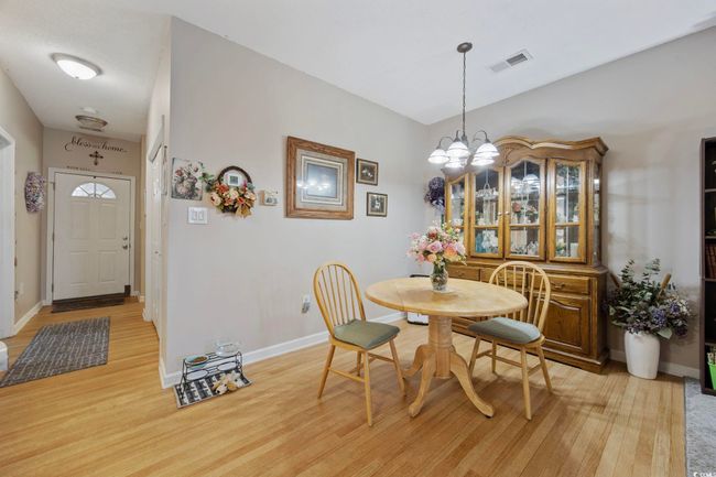 Dining space with a chandelier, light wood-type flooring, and baseboards | Image 7