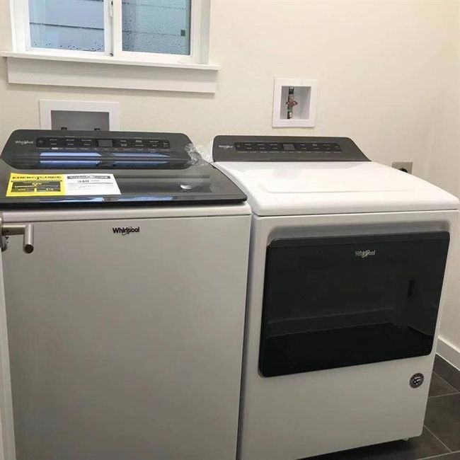 Laundry room with washing machine and dryer and tile patterned flooring | Image 26