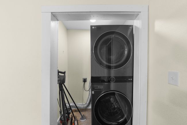 Washroom featuring stacked washer / dryer | Image 9