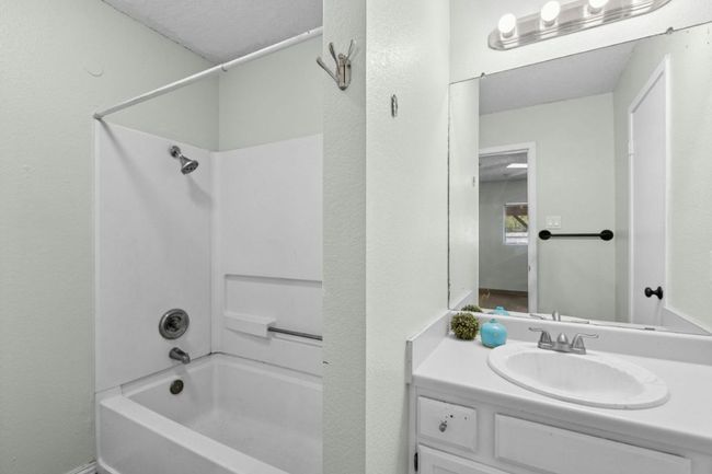 Full bath with shower / bathtub combination, vanity, and a textured wall | Image 27