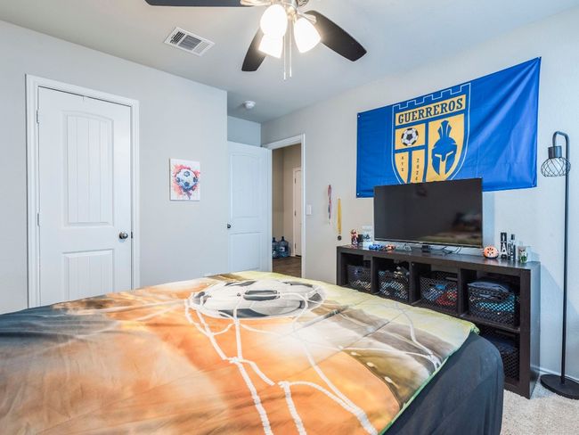 Bedroom with carpet flooring, visible vents, and a ceiling fan | Image 24