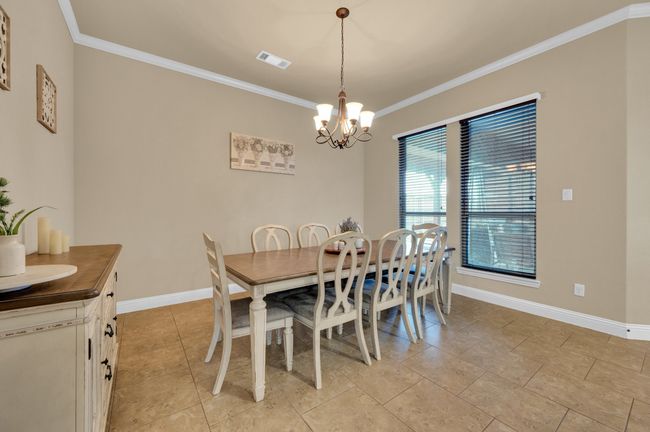 Dining area with a chandelier, crown molding, and baseboards | Image 11
