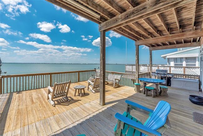 This upper deck offers both covered and open areas, with plenty of space for dining, lounging, and enjoying time around the included outdoor furniture. | Image 35