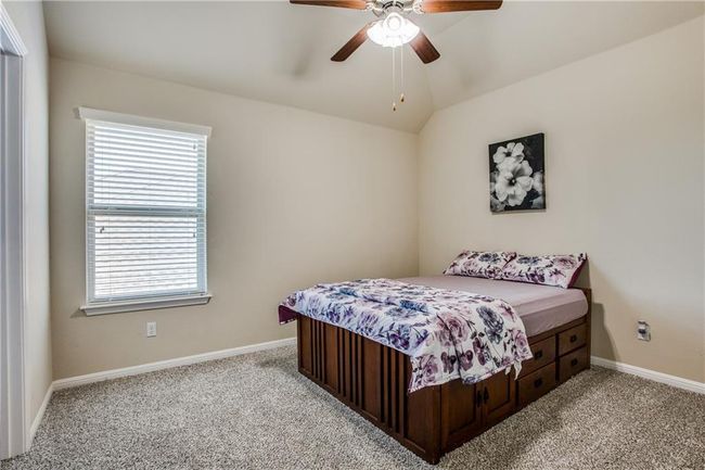 Bedroom with multiple windows, light carpet, ceiling fan, and vaulted ceiling | Image 18