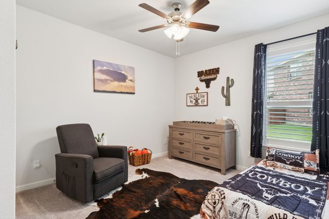 Bedroom with light carpet and ceiling fan | Image 19