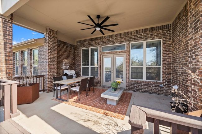 You are going to fall in love with this outdoor covered patio complemented byt an oversized ceiling fan to keep those mosquitos away. | Image 35