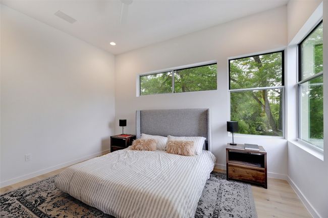 Bedroom featuring recessed lighting, baseboards, multiple windows, and light wood-style floors | Image 13