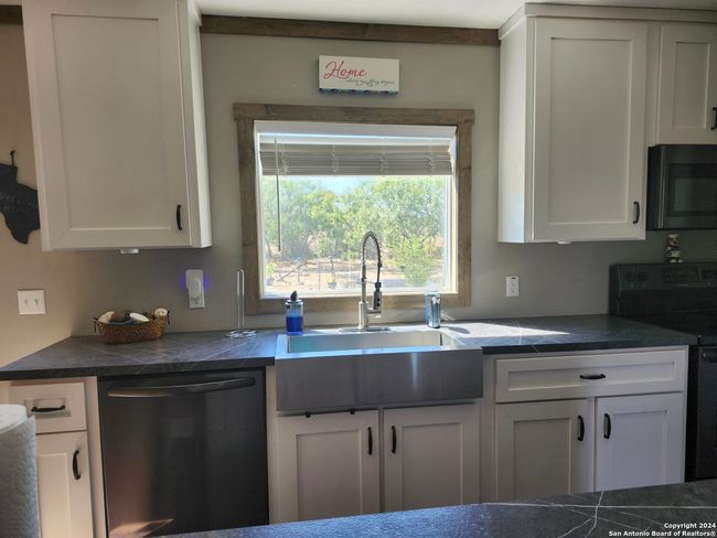 Kitchen with a view to the back yard | Image 7