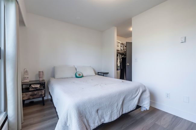 Bedroom featuring a closet, baseboards, a walk in closet, and wood finished floors | Image 17