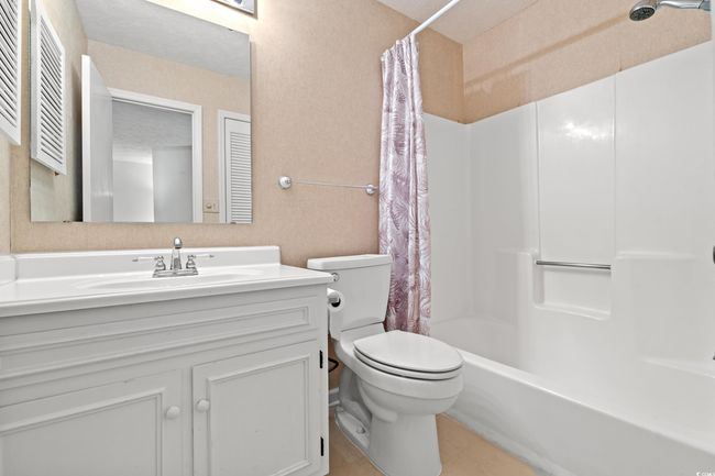 Full bathroom with vanity, shower / bath combo, and tile patterned floors | Image 26