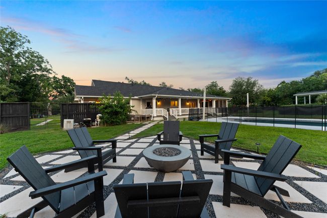 Pavers along the backyard and fire pit area create a cozy space for winter nights | Image 31