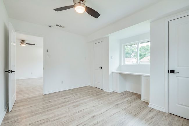 Unfurnished room with a ceiling fan and light wood-style flooring | Image 19