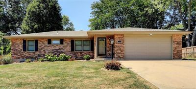 Single story home featuring a garage and a front yard | Image 2