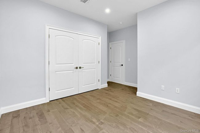 Unfurnished bedroom with light wood-style floors and a closet | Image 18
