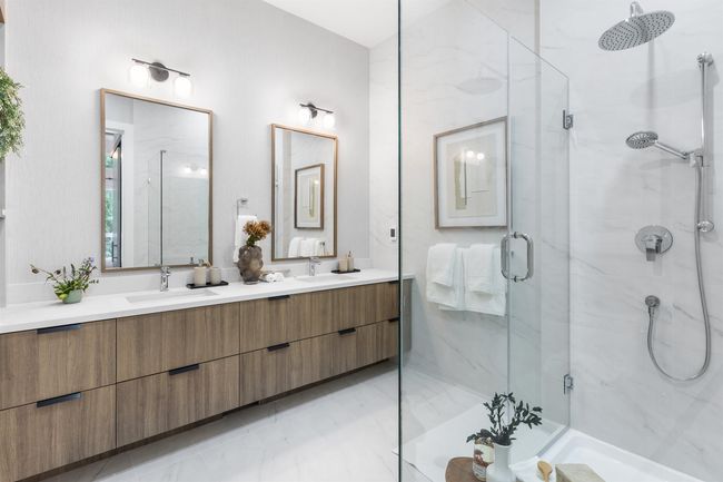 Full bathroom featuring a marble finish shower and double vanity | Image 5