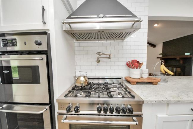 With a 5-burner gas range, large oven, two electric wall ovens, and a convenient pot filler—this kitchen is built for holiday feasts, Sunday brunches, and everything in between. | Image 12
