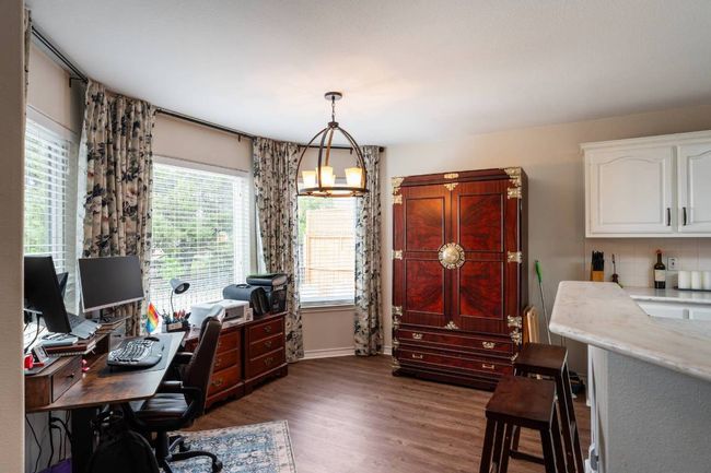 Office area featuring baseboards and dark wood finished floors | Image 6