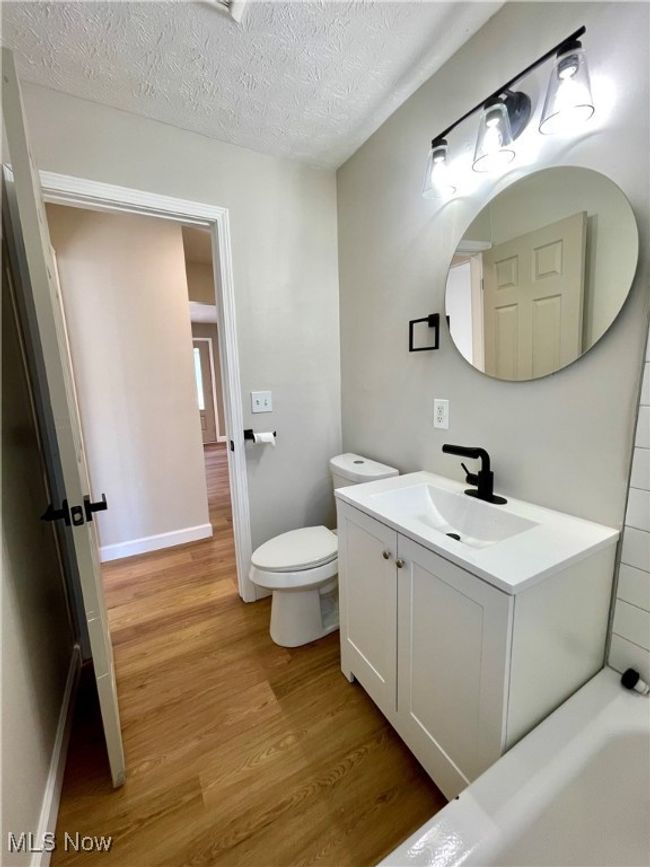 Bathroom featuring wood finished floors, vanity, and a textured ceiling | Image 18