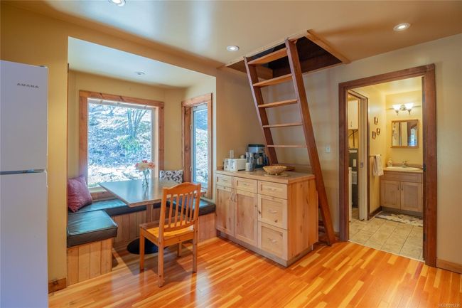 Kitchen and eating area with ship ladder up to the loft | Image 18