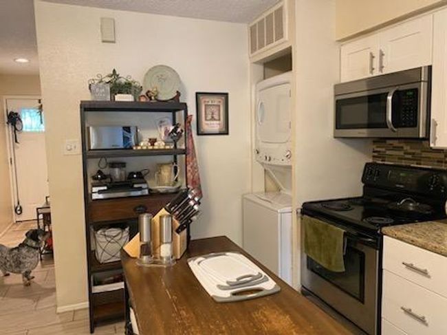 Convenient stacked washer and dryer in kitchen for easy access to all residents. | Image 4
