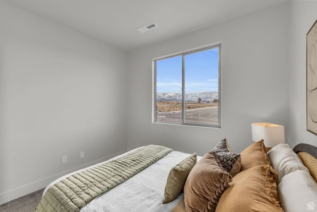 Bedroom featuring a mountain view and carpet floors | Image 25