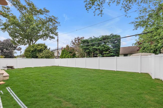 View of fenced backyard | Image 16