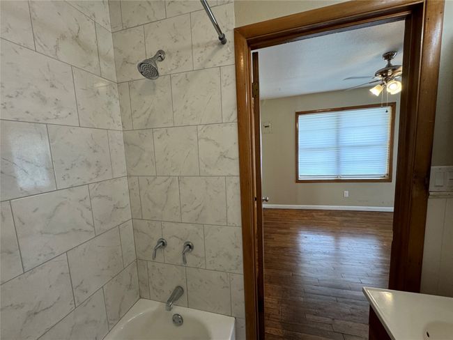 Unit A bathroom with tiled tub shower combo | Image 16