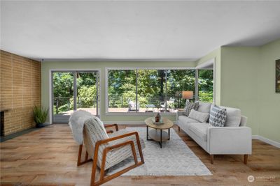 Entertainer's dream living room with expansive windows offering stunning views of the outdoors. | Image 2