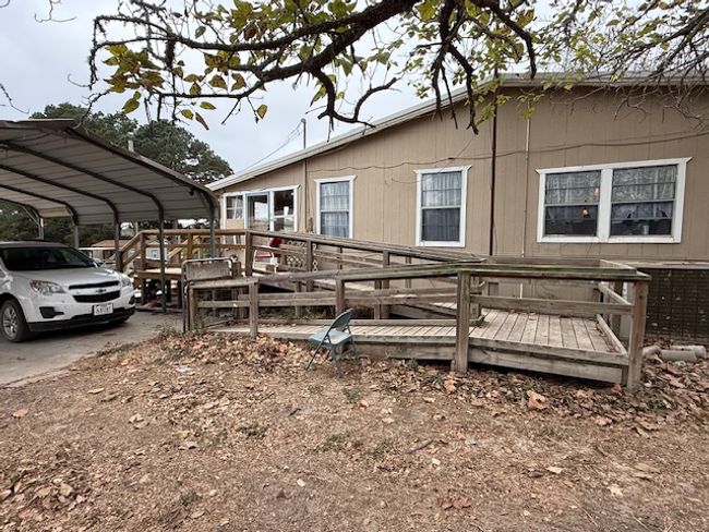 View of side of home with a carport and a deck | Image 13