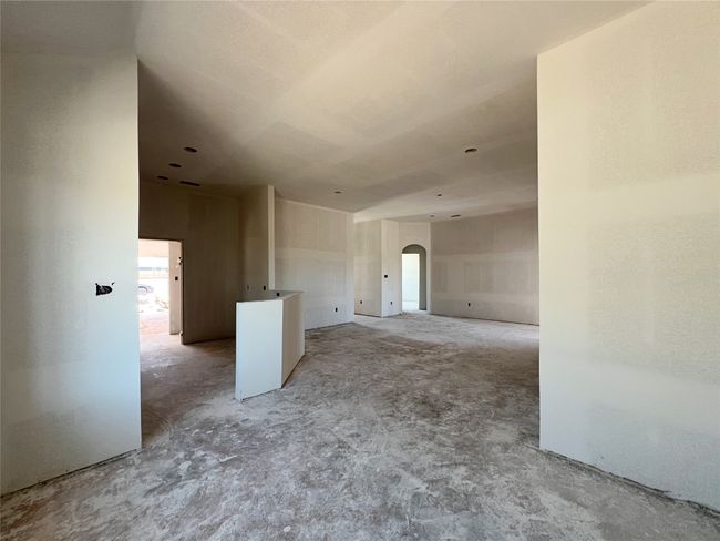View from dining looking in to the kitchen and living room areas. | Image 6