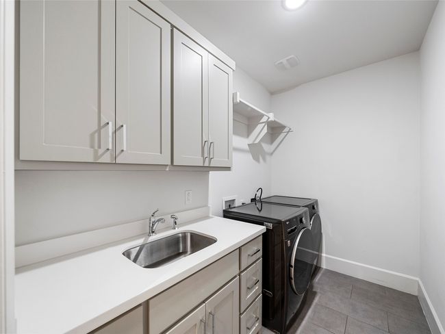 1st floor Laundry area featuring washer and dryer and cabinet space | Image 38