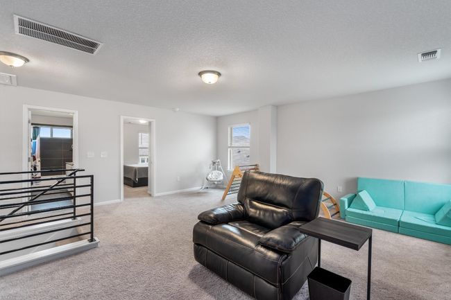 Carpeted living room with baseboards and a textured ceiling | Image 22