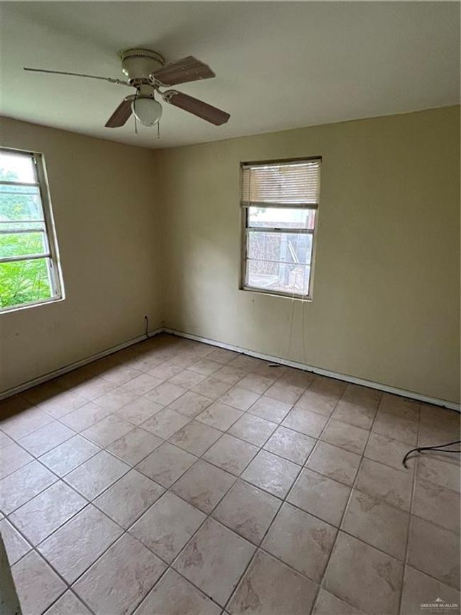 Unfurnished room with light tile patterned flooring and ceiling fan | Image 9