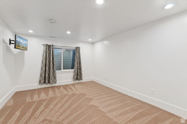 Empty room with a smoke detector, recessed lighting, and carpet | Image 30