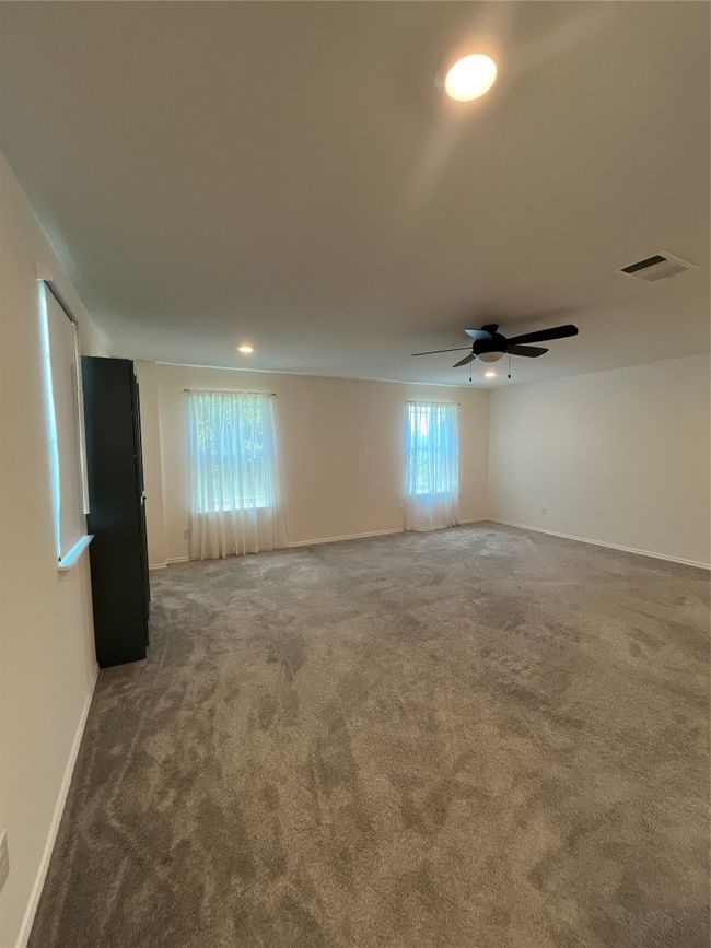 Empty room featuring baseboards, visible vents, ceiling fan, and carpet | Image 19
