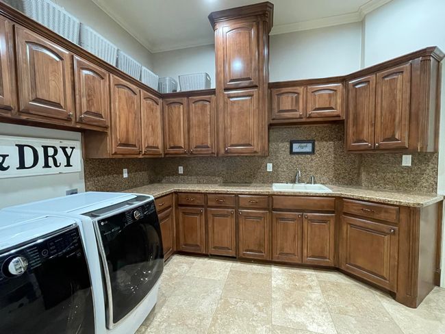 Laundry room with laundry from shoot and plenty of storage | Image 21